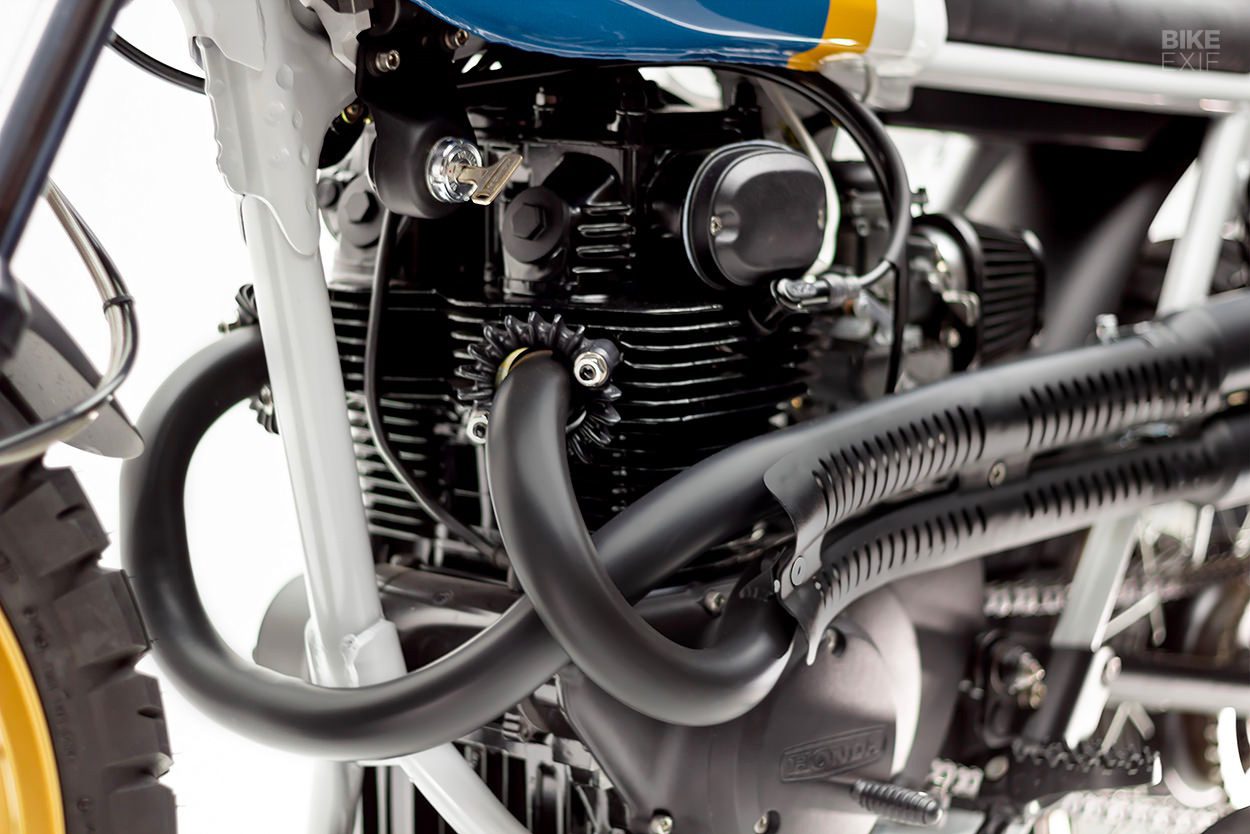 an all-black engine from a custom Honda scrambler motorcycle by Slipstream Customs