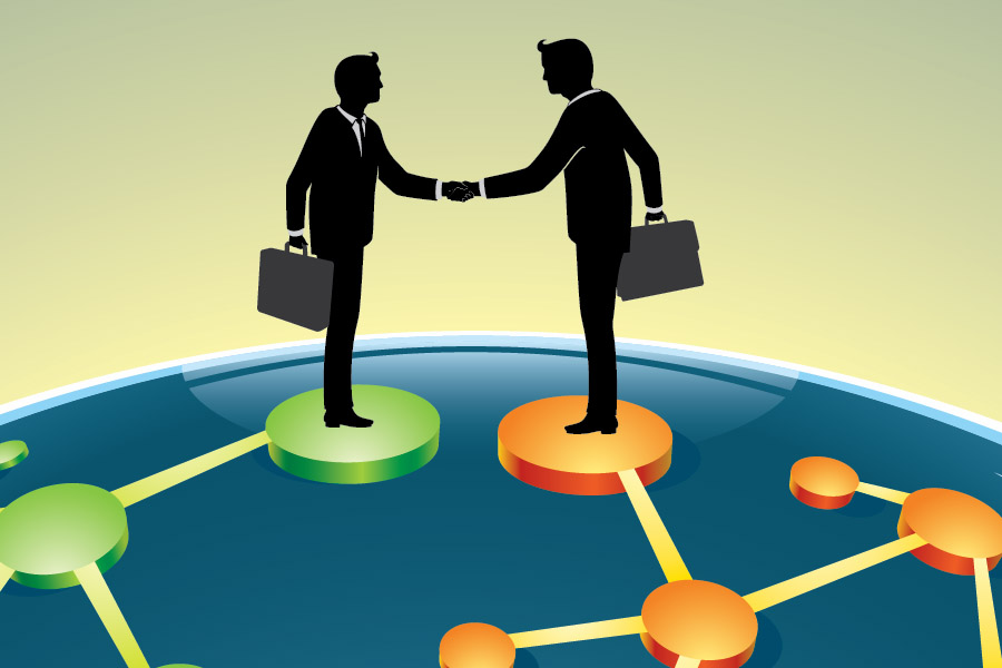 A view of two businessmen shaking hands in a merger agreement