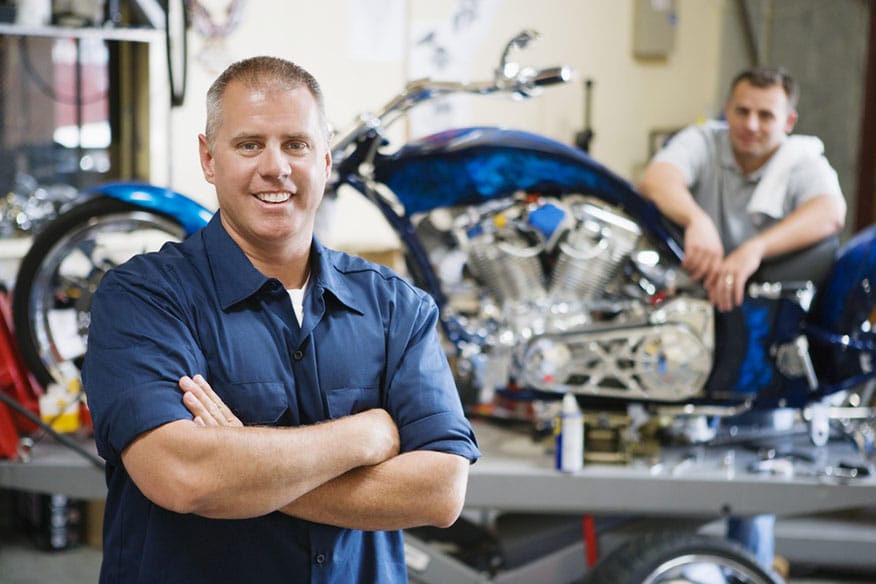 A view of two people at work in the back of a dealership