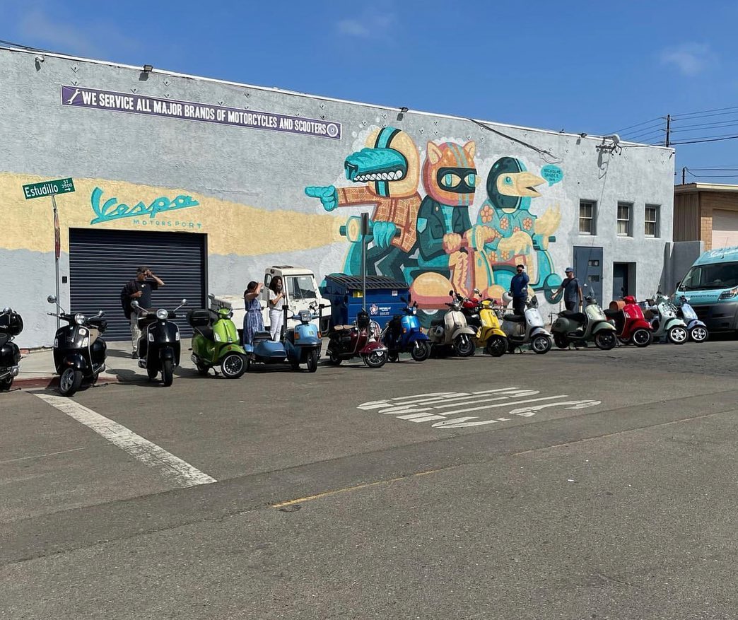 A group of riders from the Vespa Club of America