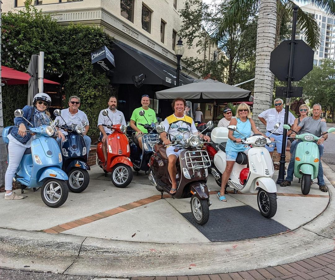 A group of riders from the Vespa Club of America