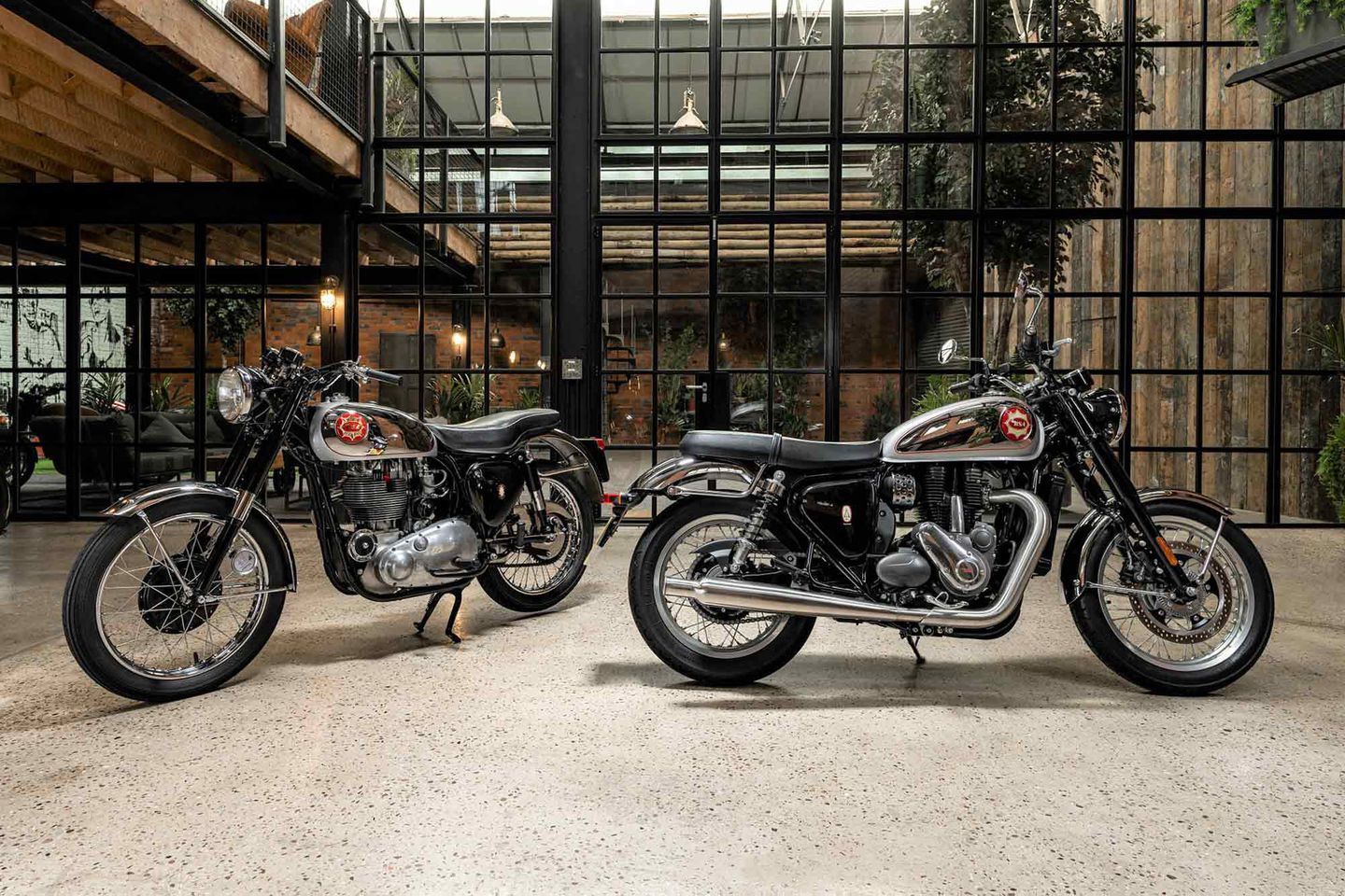 Old and new Gold Star 650 motorcycles indoors at BSA headquarters in the UK