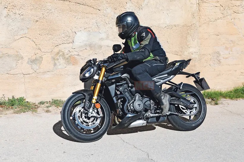 A view of the new machine that Triumph's been taking out for tests - note the new gold Ohlins suspension, the changes to the bodywork, splitter at the front, and higher raised clip-ons.