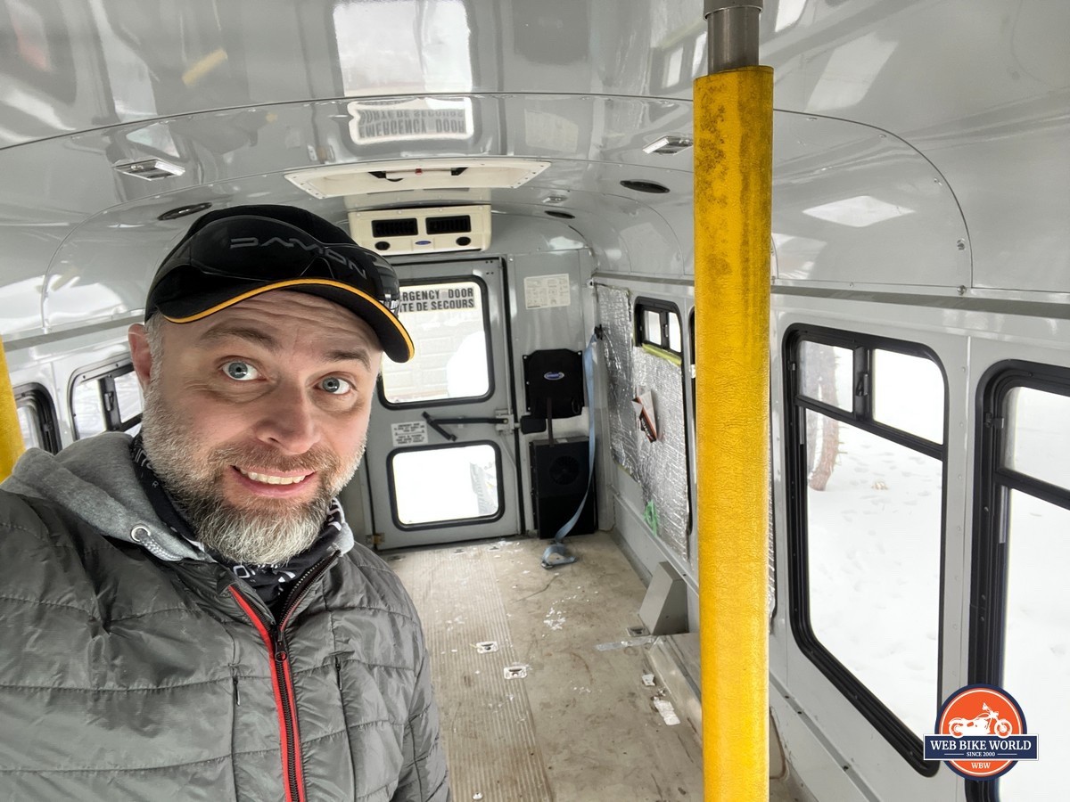 Author smiling and standing inside 2004 Ford E-350 Cutaway van