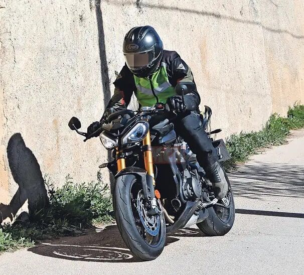 A view of the new machine that Triumph's been taking out for tests - note the new gold Ohlins suspension, the changes to the bodywork, splitter at the front, and higher raised clip-ons.