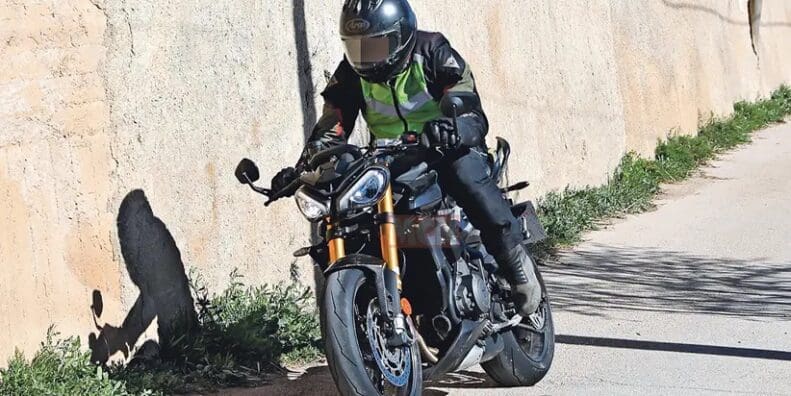 A view of the new machine that Triumph's been taking out for tests - note the new gold Ohlins suspension, the changes to the bodywork, splitter at the front, and higher raised clip-ons.