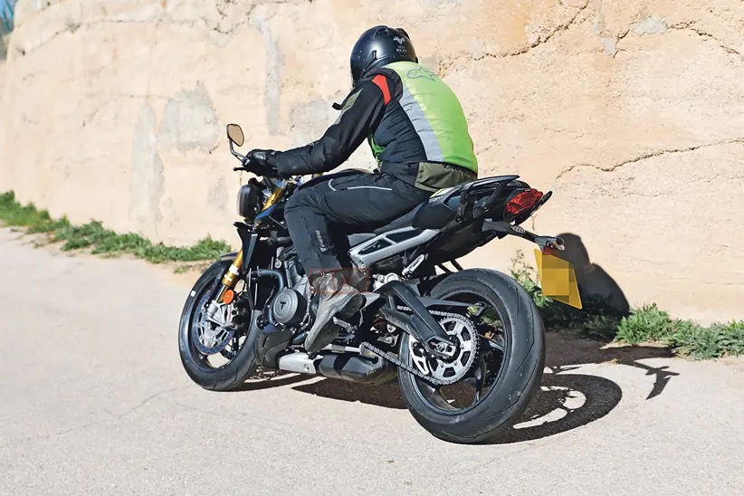 A view of the new machine that Triumph's been taking out for tests - note the new gold Ohlins suspension, the changes to the bodywork, splitter at the front, and higher raised clip-ons.