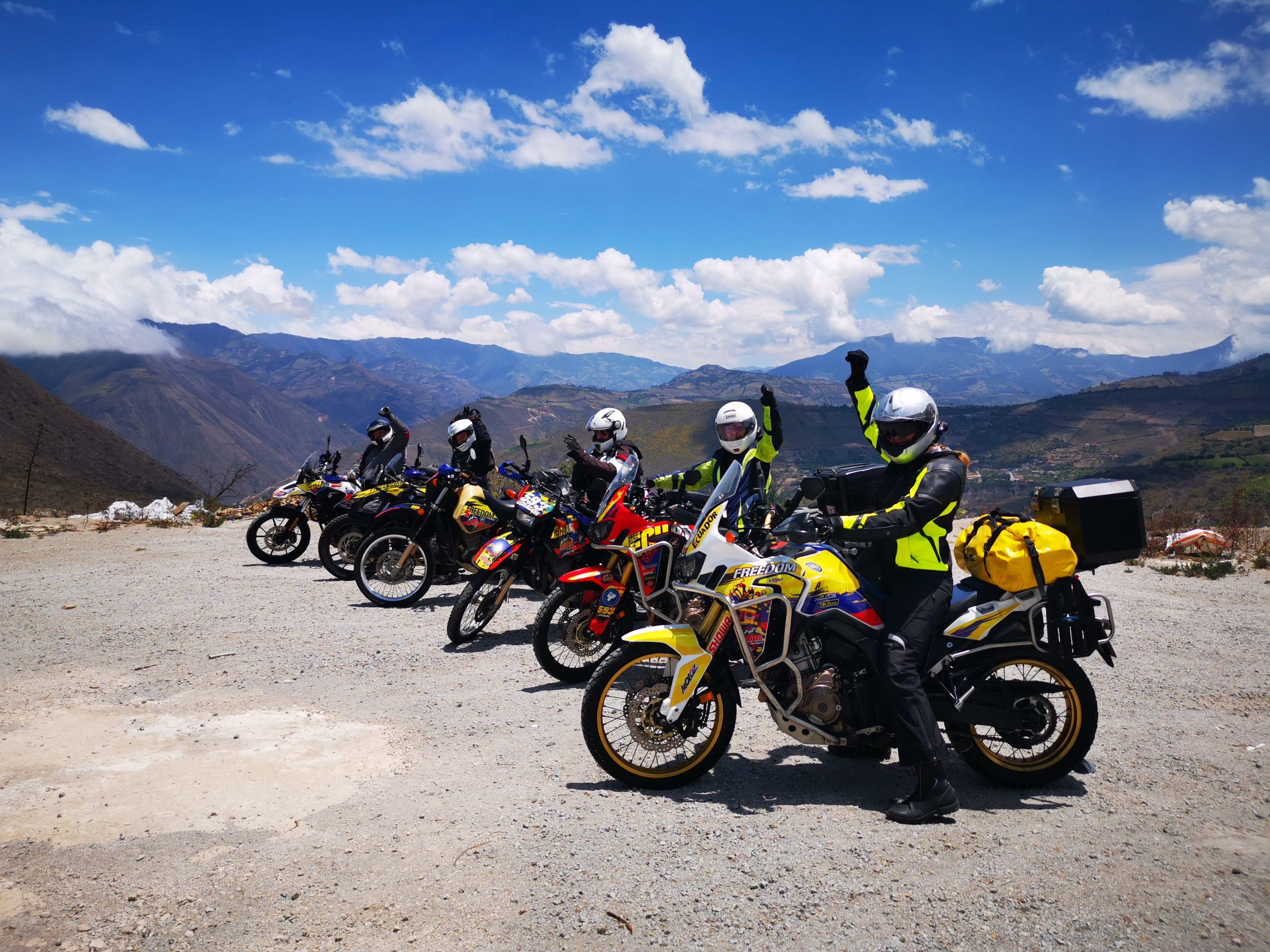 Female adventure motorcycle riders enjoying a blue sky and sunshine