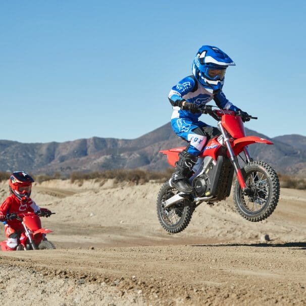 A young rider riding the dirt on a CRF-E2