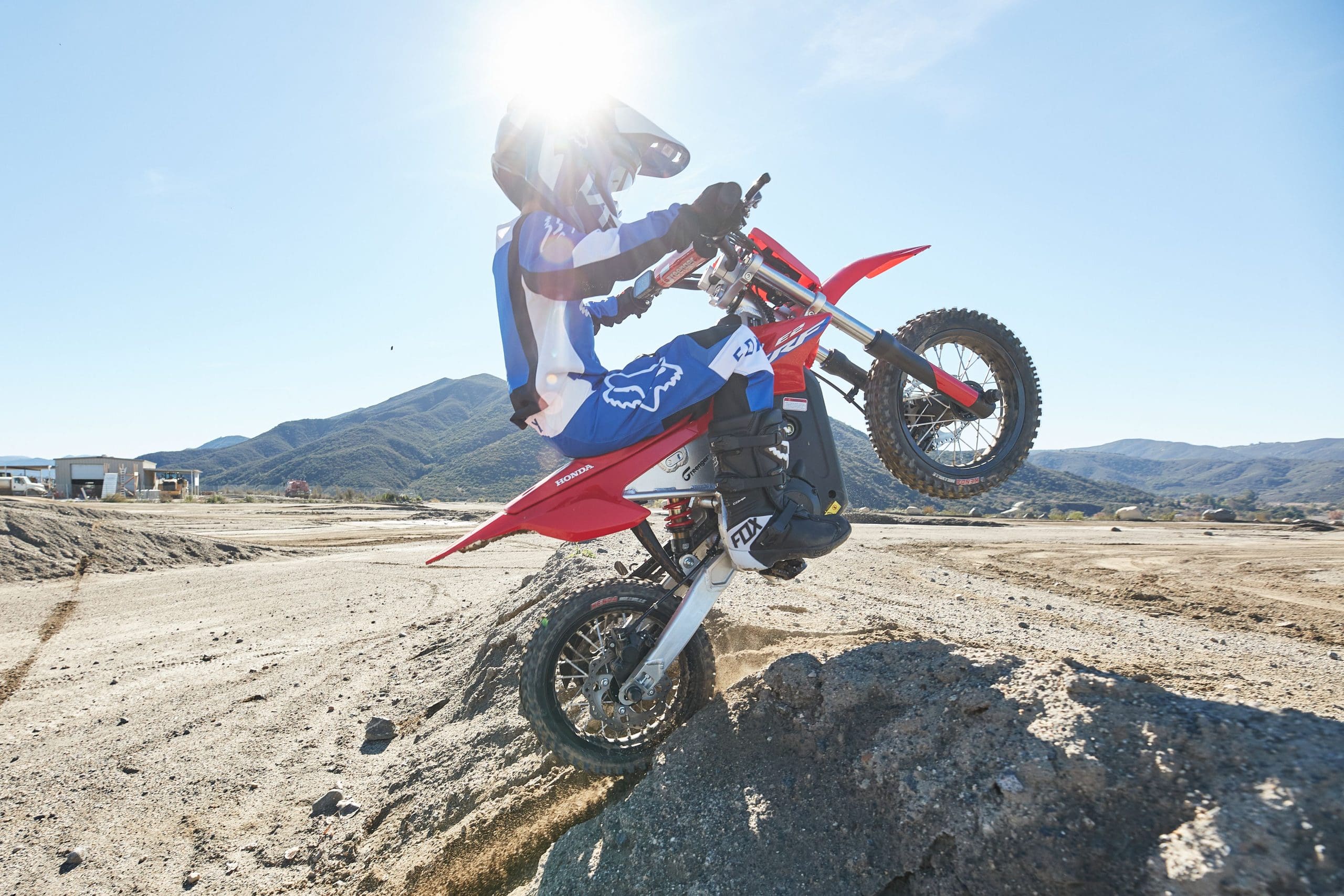 A young rider riding the dirt on a CRF-E2