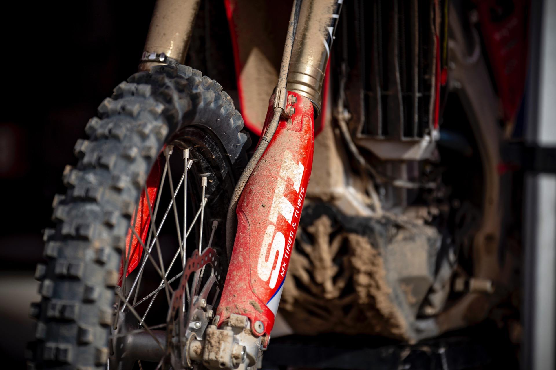 Closeup of muddy front fork suspension on motorcycle