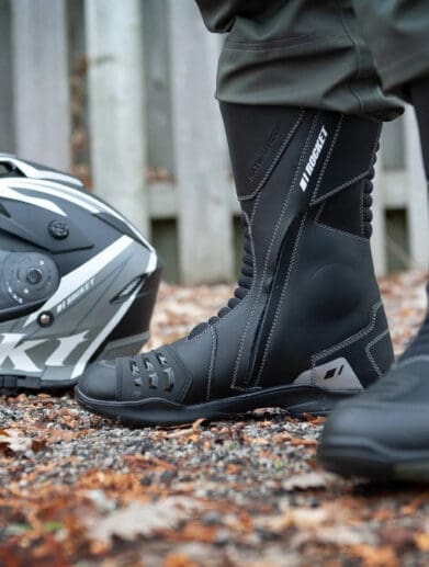 Woman wearing Joe Rocket boots before spring ride with helmet nearby