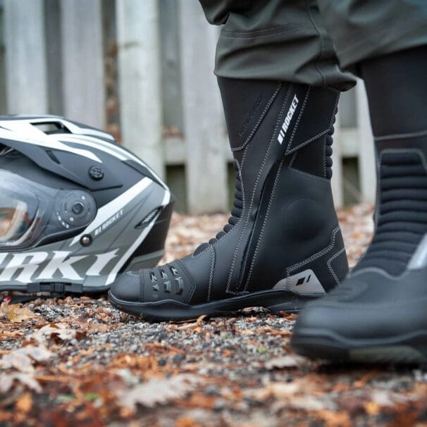 Woman wearing Joe Rocket boots before spring ride with helmet nearby