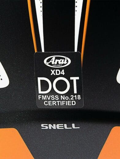 The safety certification sticker from an Arai XD4 helmet