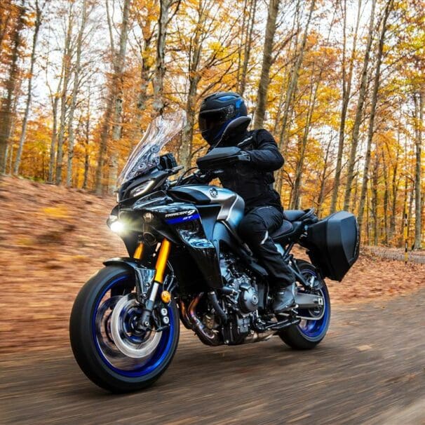 Rider on a Yamaha Tracer 9 GT riding through the woods