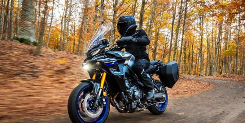 Rider on a Yamaha Tracer 9 GT riding through the woods