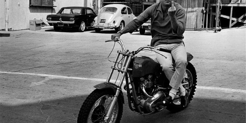 Steve McQueen on his Metisse Desert Racer in a Hollywood lot car park