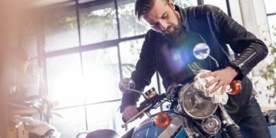 man fixing a motorcycle in garage