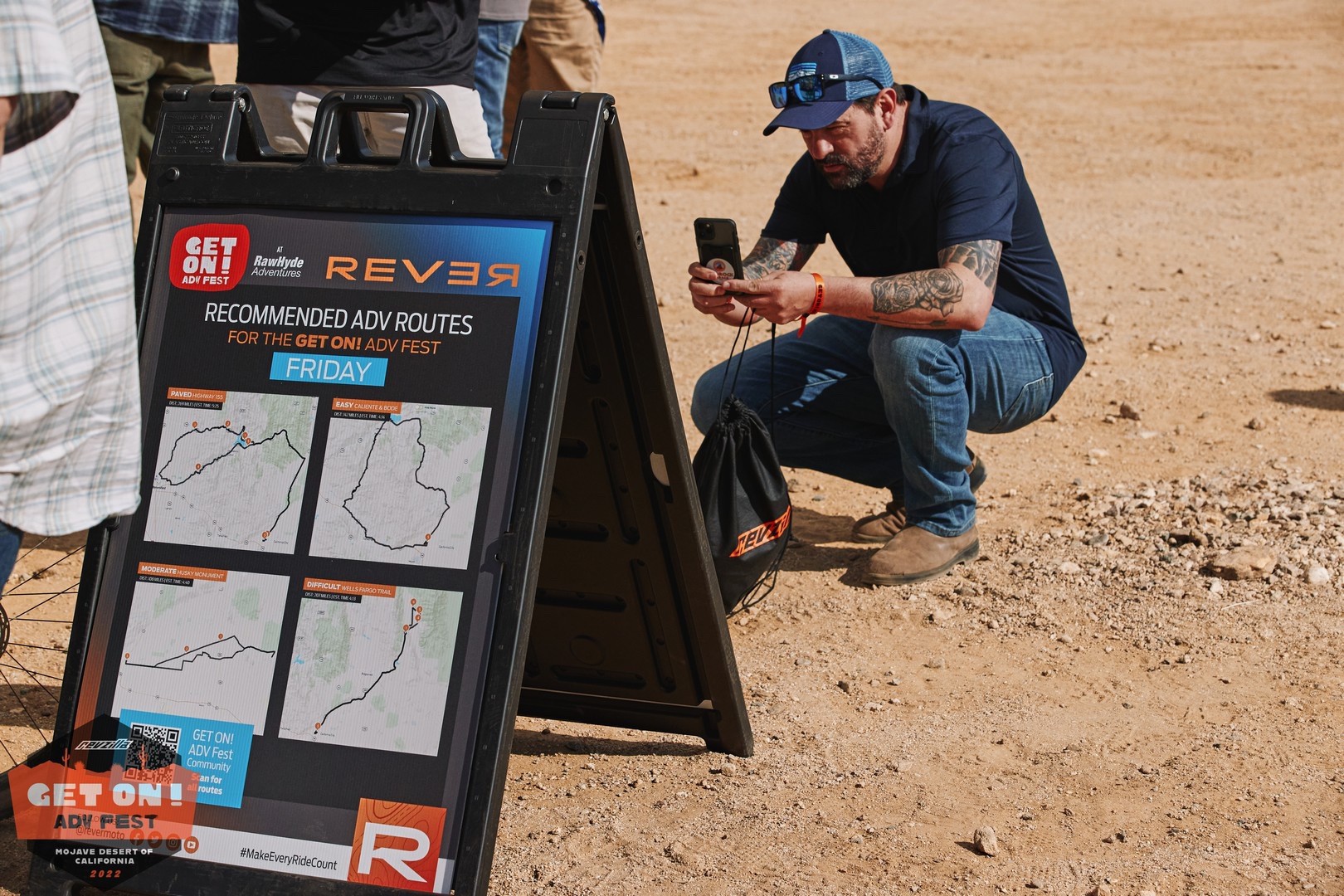 A rider downloads a route from the Rever board at the GET ON! Adv Fest rally in Mojave.