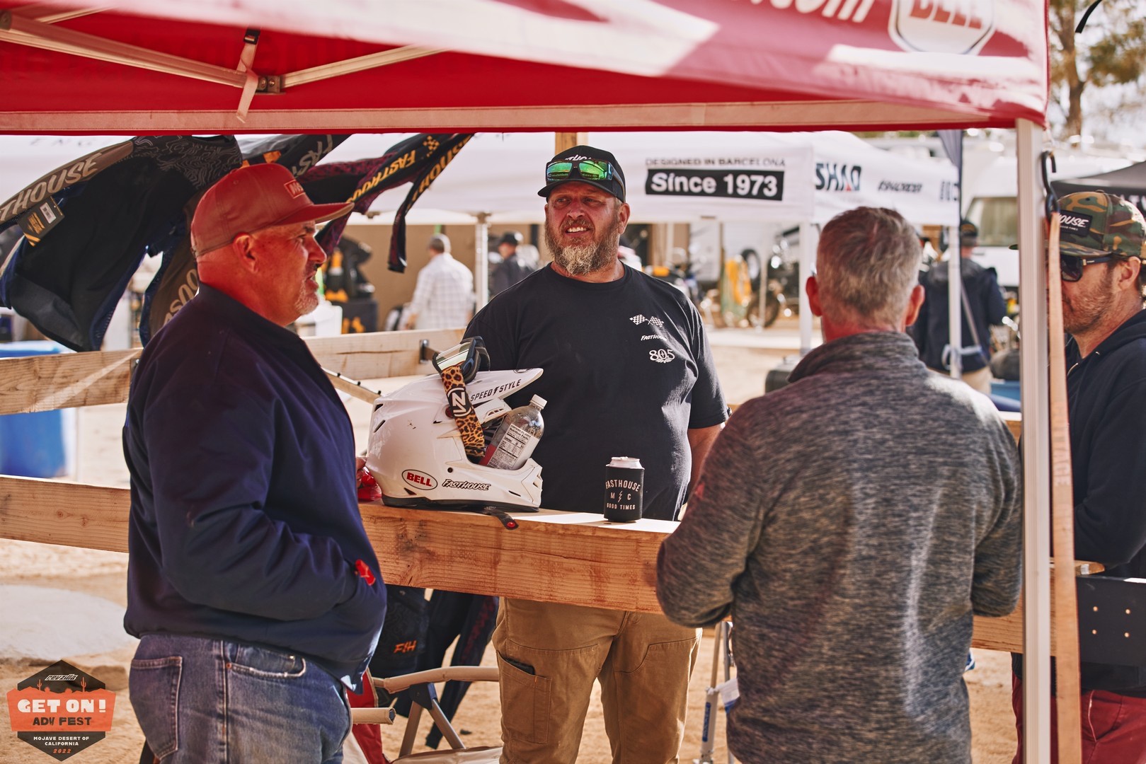 Eric Wright and Chris Sackett from Fasthouse chat with participants at the GET ON! Adv Fest rally in Mojave.
