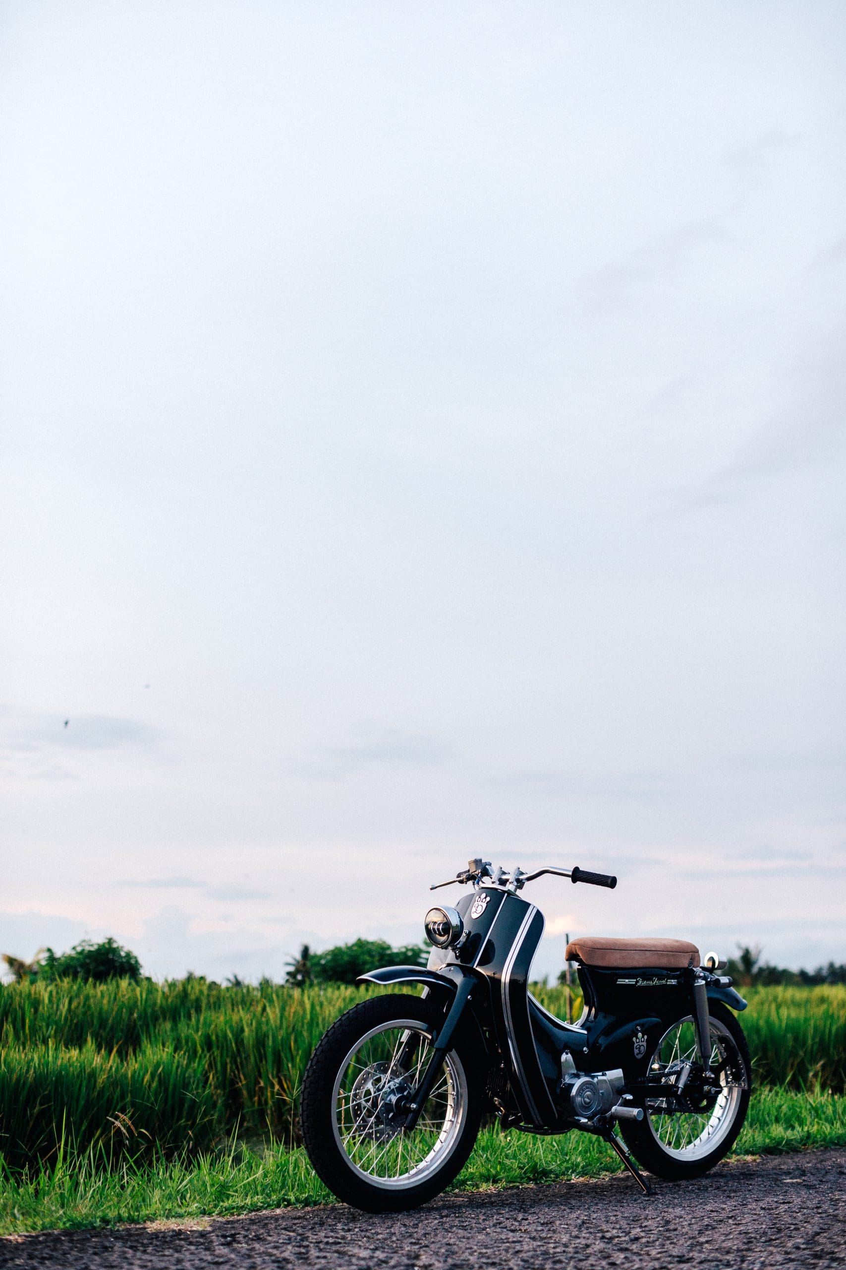 A view of the Honda Cub that was tricked out and refreshed by iconic custom bike shop Deus Customs