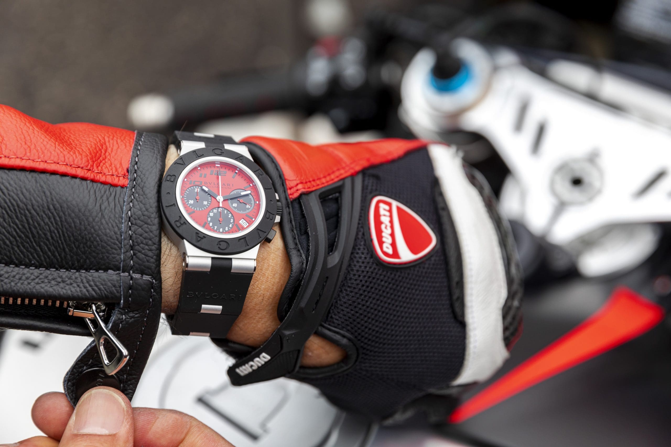 A motorcyclist showcasing the Bulgari Aluminum Ducati Special Edition chronograph, which is now available on Bulgari's webpage for $5,000 and is advertised as "The best Bulgari watch ever made."