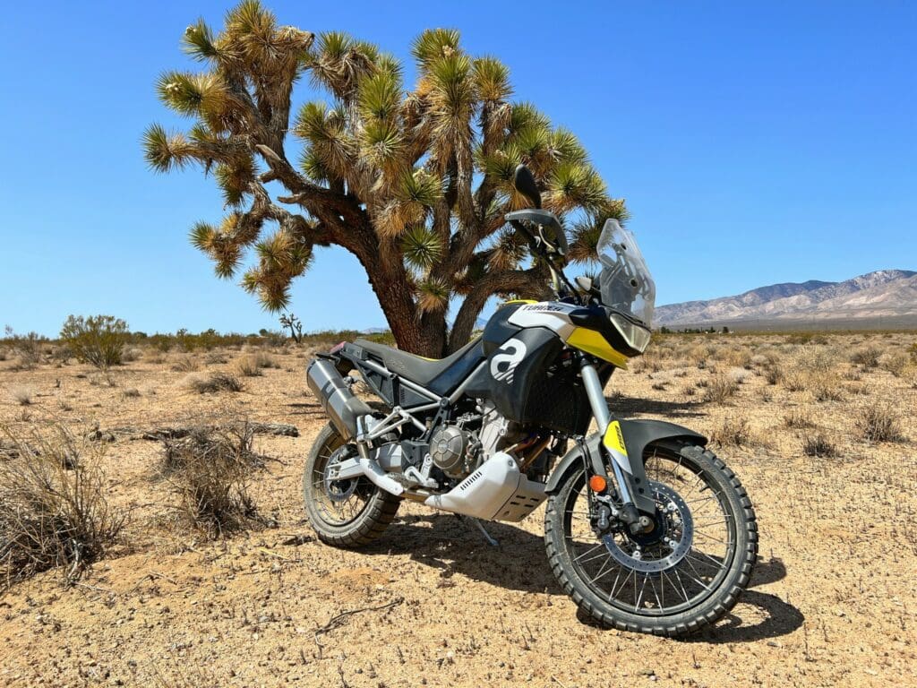 The 2022 Aprilia Tuareg 660 by a Joshua Tree in Mojave, California.