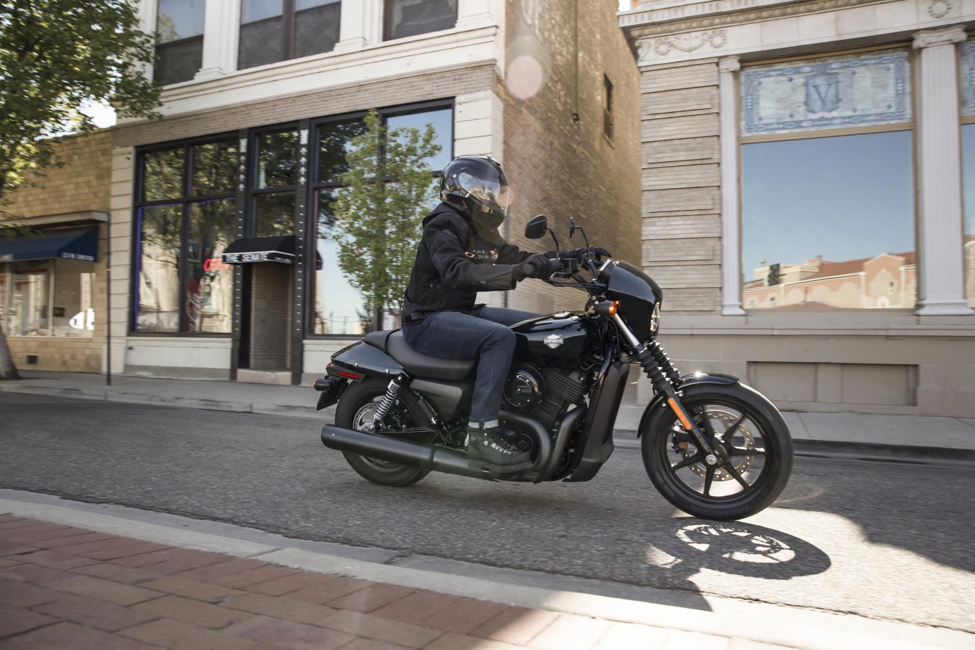 A Harley-Davidson Street 500 motorcycle rides downs a street during a launch event in America.