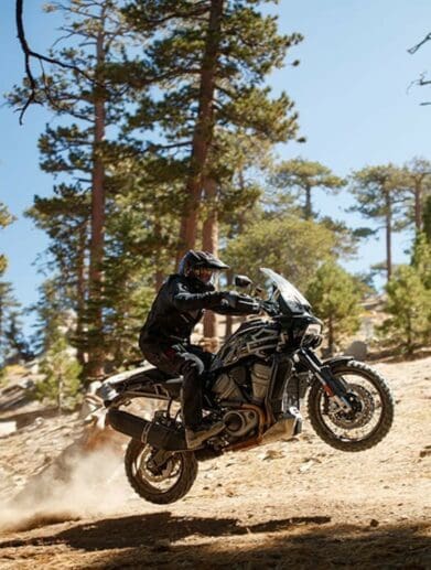 A new Harley-Davidson Pan America motorcycle launches of a jump in a desert during the North American launch.