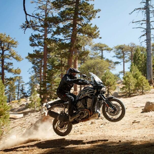 A new Harley-Davidson Pan America motorcycle launches of a jump in a desert during the North American launch.