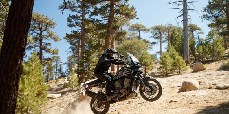 A new Harley-Davidson Pan America motorcycle launches of a jump in a desert during the North American launch.