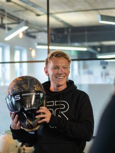 Taylor Mackenzie announces his partnership with Ruroc while holding the recent Atlas 4.0 motorcycle helmet. Photo courtesy of Ruroc's press release.