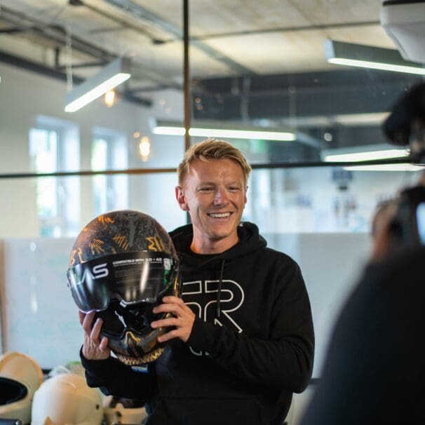 Taylor Mackenzie announces his partnership with Ruroc while holding the recent Atlas 4.0 motorcycle helmet. Photo courtesy of Ruroc's press release.