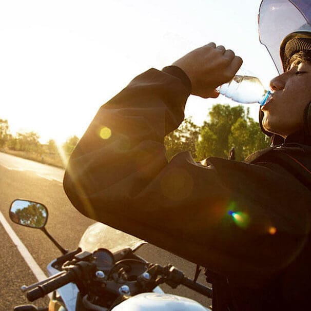 A female motorcycle rider drinking water on a break. Photo courtesy of the Orangeville country BMW Dealership.