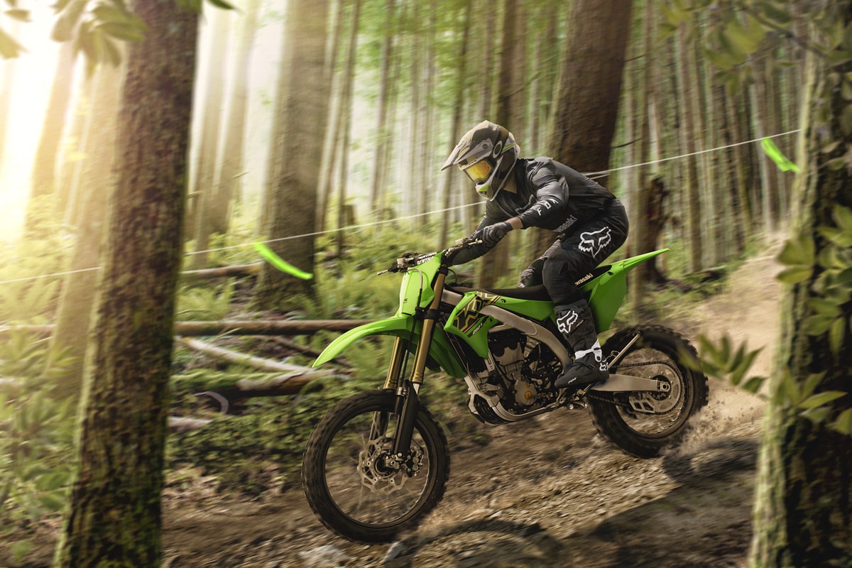 A Kawi bike begin ridden through the forest.