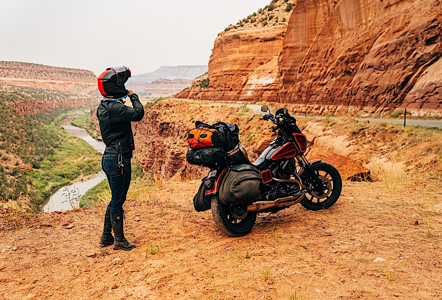 A view of a motorcycle rider experiencing beautiful topography and prepping to avoid heat exhaustion.