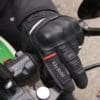 Left Richa Atlantic GTX glove holding motorcycle handlebar