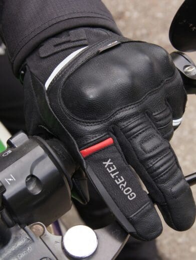 Left Richa Atlantic GTX glove holding motorcycle handlebar