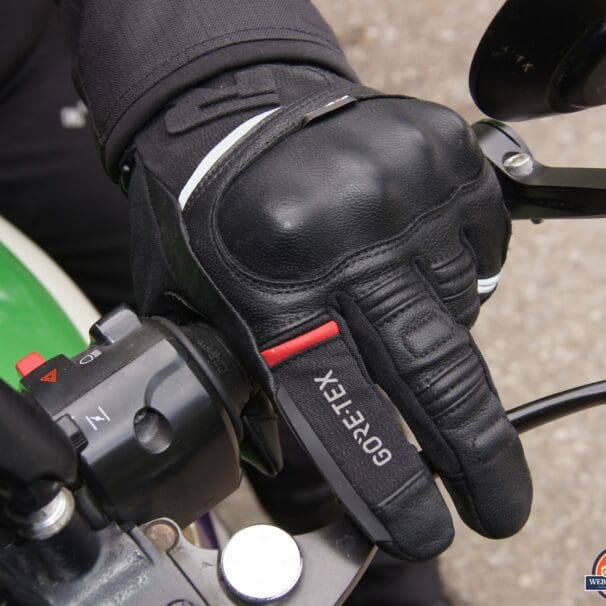 Left Richa Atlantic GTX glove holding motorcycle handlebar