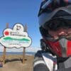 Me in front of the welcome sign for the village of Tuktoyaktuk, NWT.