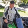 Author sitting on Kawasaki motorcycle while wearing Gryphon Moto Blue Ridge Jacket