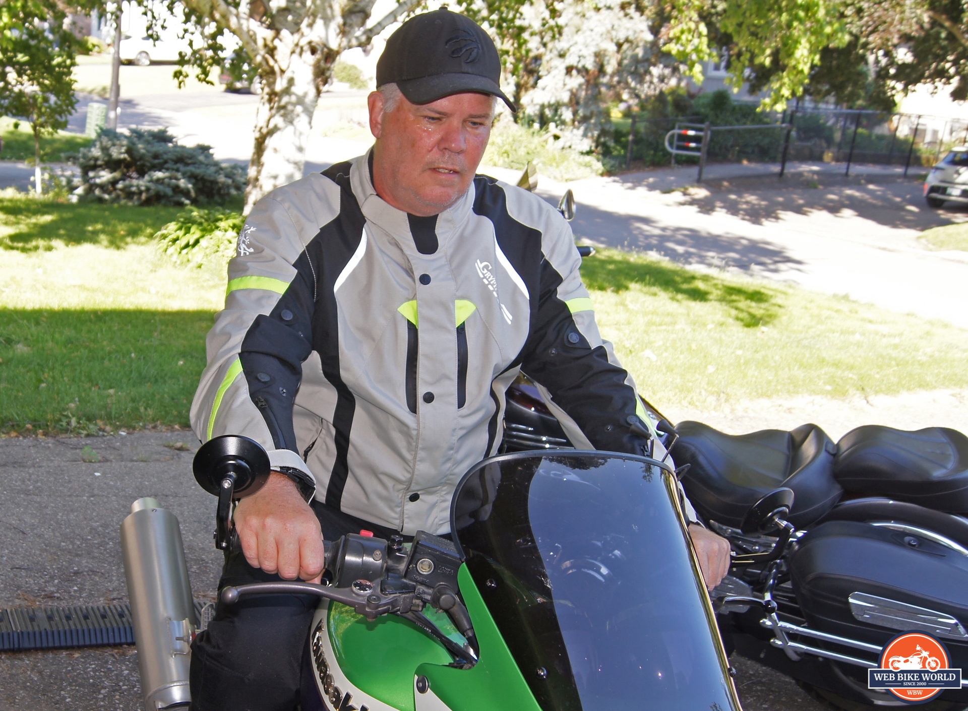 Author sitting on Kawasaki motorcycle while wearing Gryphon Moto Blue Ridge Jacket