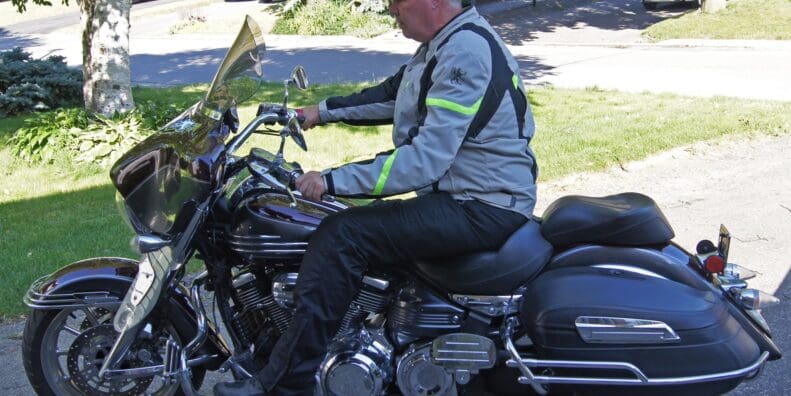 Author wearing Gryphon Moto Copper Canyon Pants while riding cruiser motorcycle