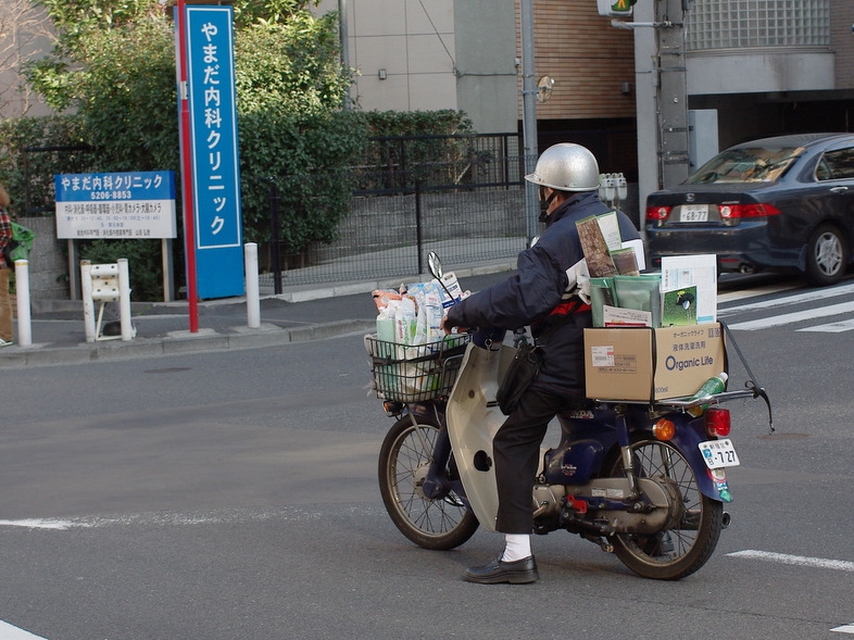 A well loved Super Cub in Tokyo, hauling cargo and making sure that everyday life goes on.