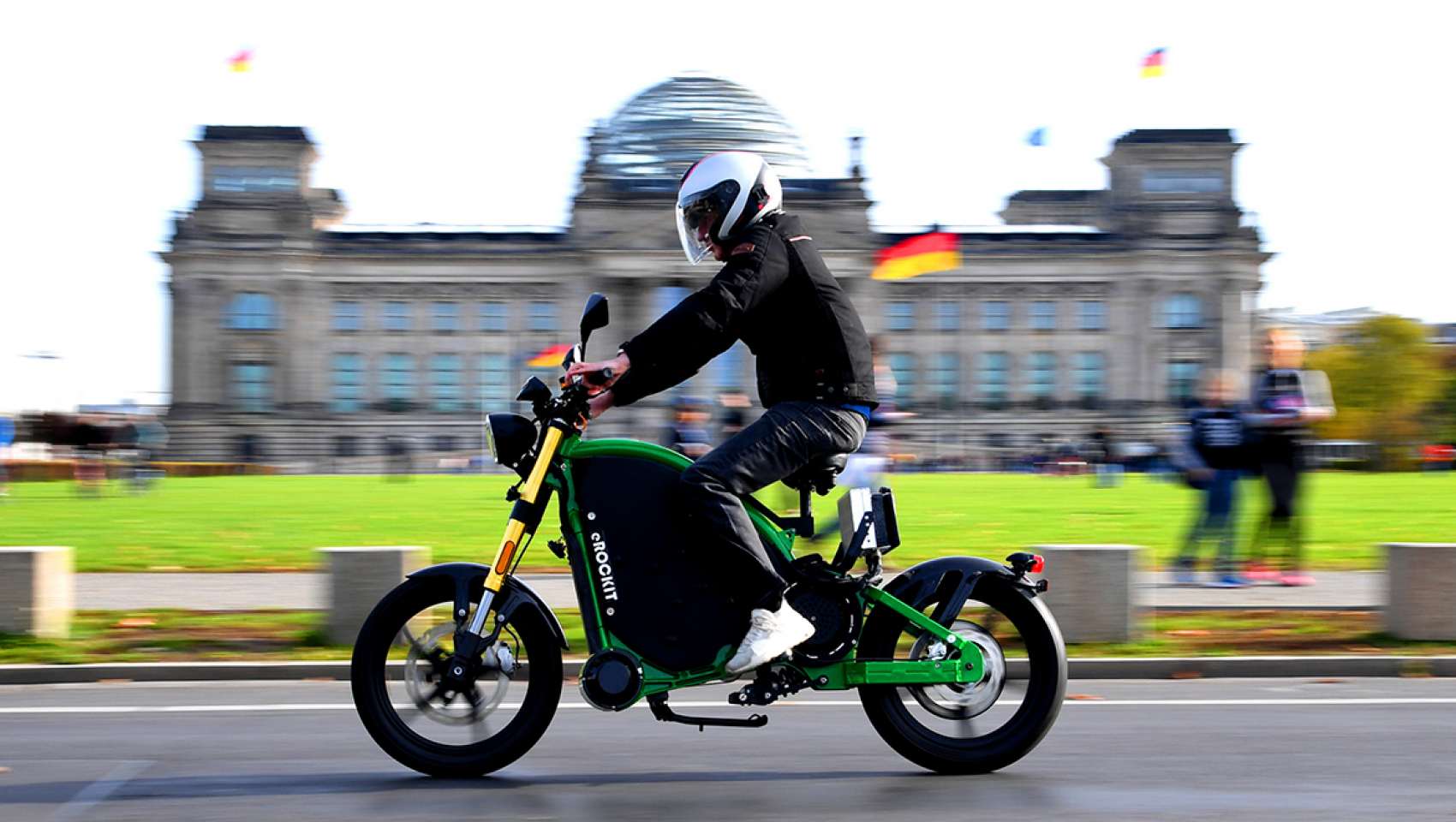 Man rides eRockit electric motorcycle at speed through a German city