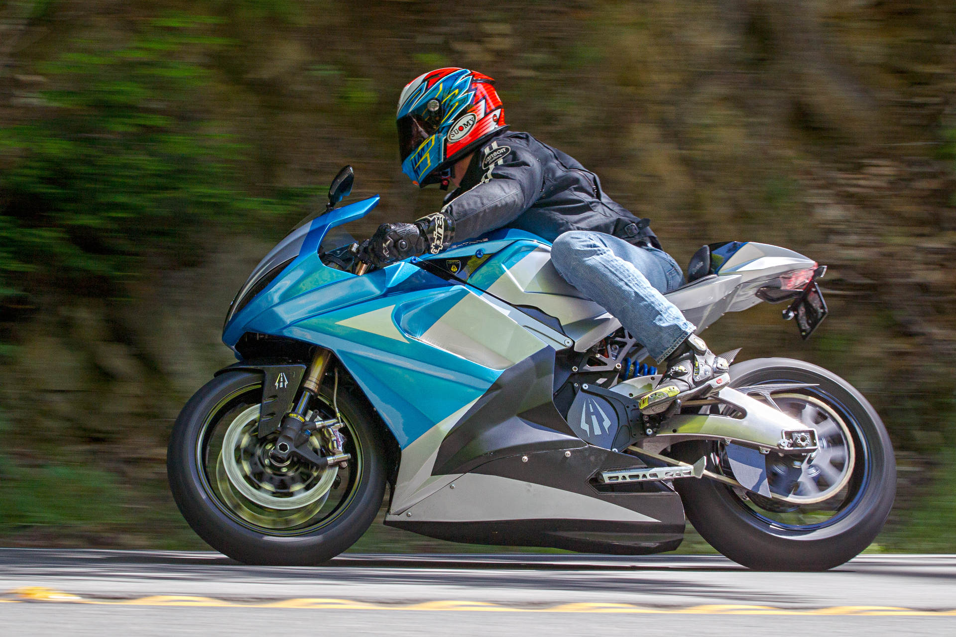 Man riding Lightning LS-218 electric motorcycle on the road at speed