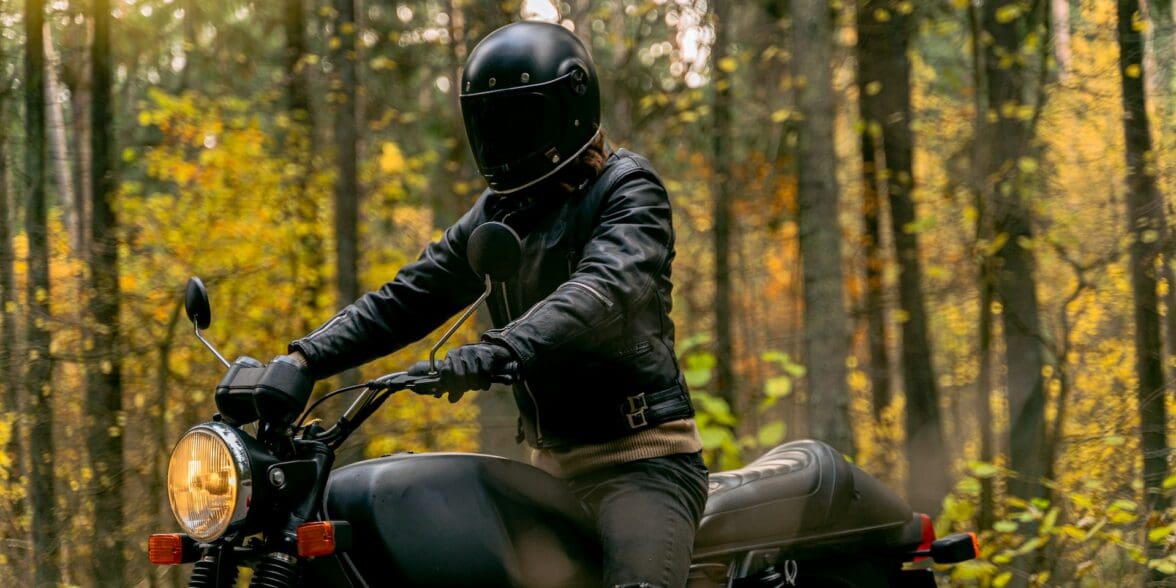 Man on a motorcycle wearing helmet and jacket