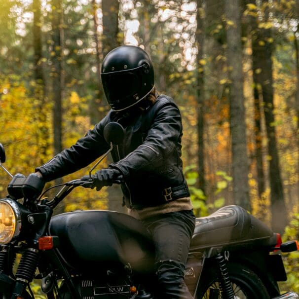 Man on a motorcycle wearing helmet and jacket