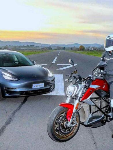 A Tesla about to duel against an EV motorcycle. Media sourced from InsideEvs.