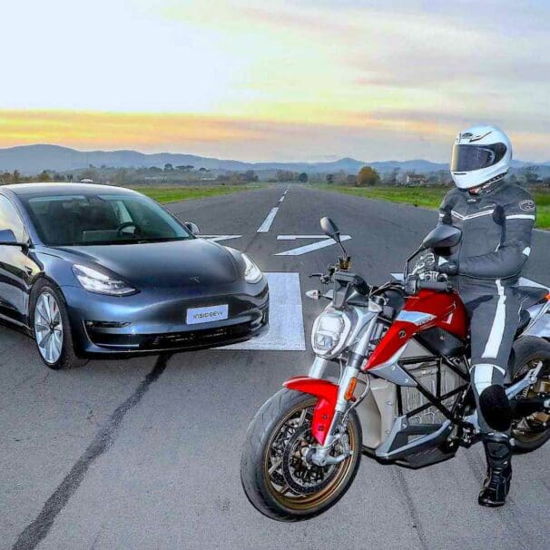 A Tesla about to duel against an EV motorcycle. Media sourced from InsideEvs.